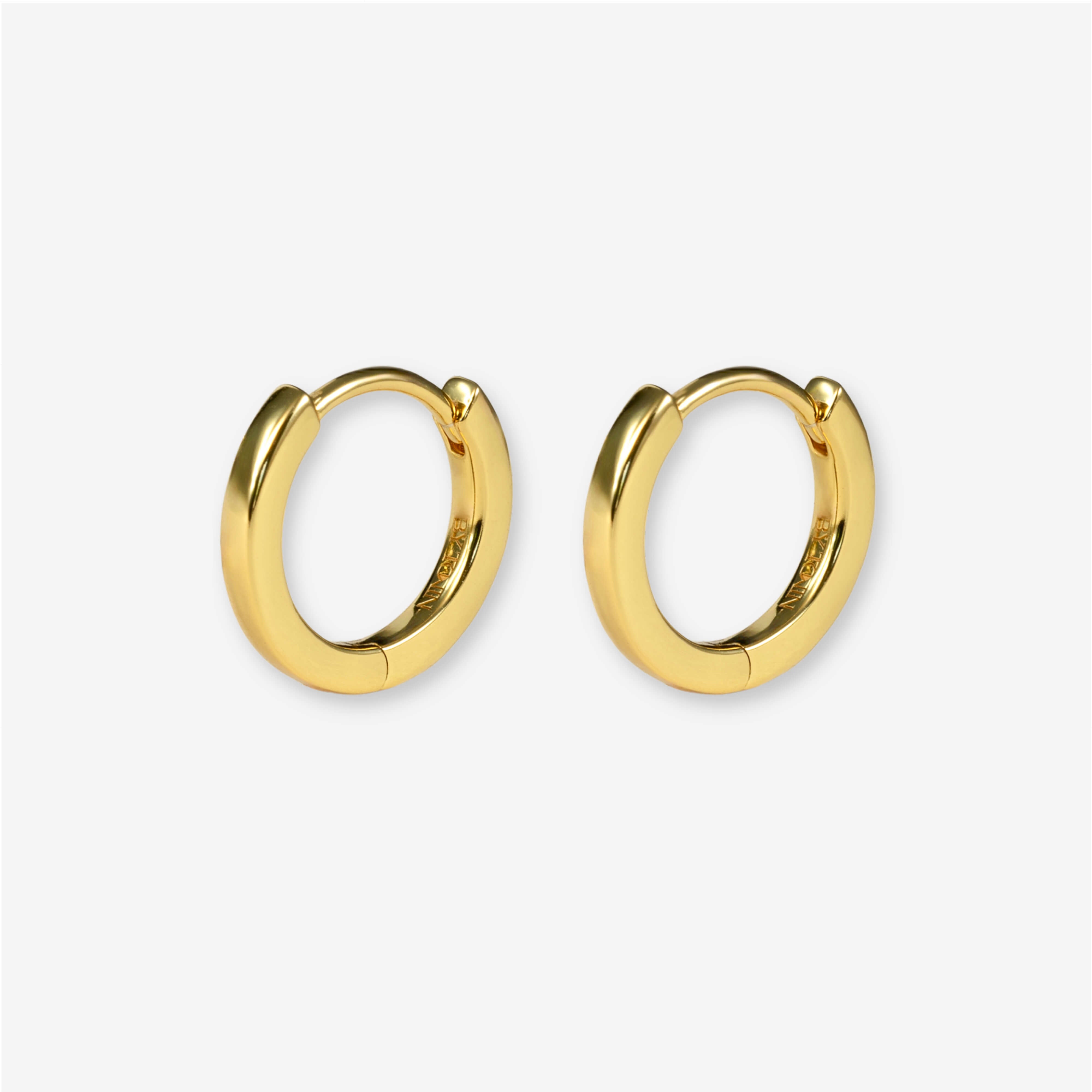 Elevate your everyday style with BY TONIN Heritage gold mini hoop earrings, featuring a flawless, polished finish for timeless elegance.