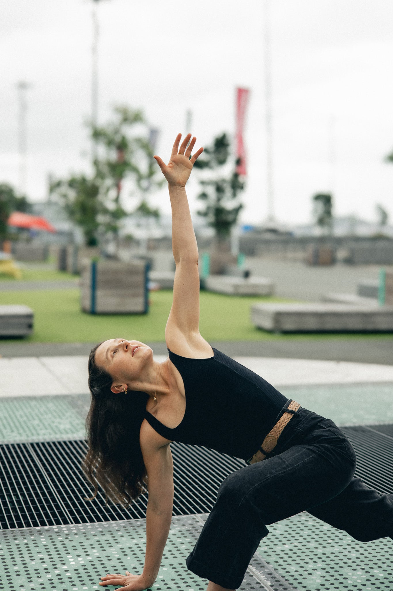 Lifestyle Shot - Model wearing necklace/earrings in an outdoor yoga pose.