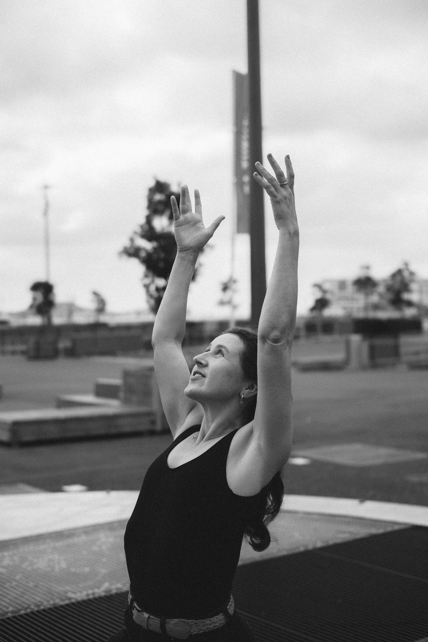 Lifestyle Shot - Black and white photo of model with arms raised, wearing the dome ring.