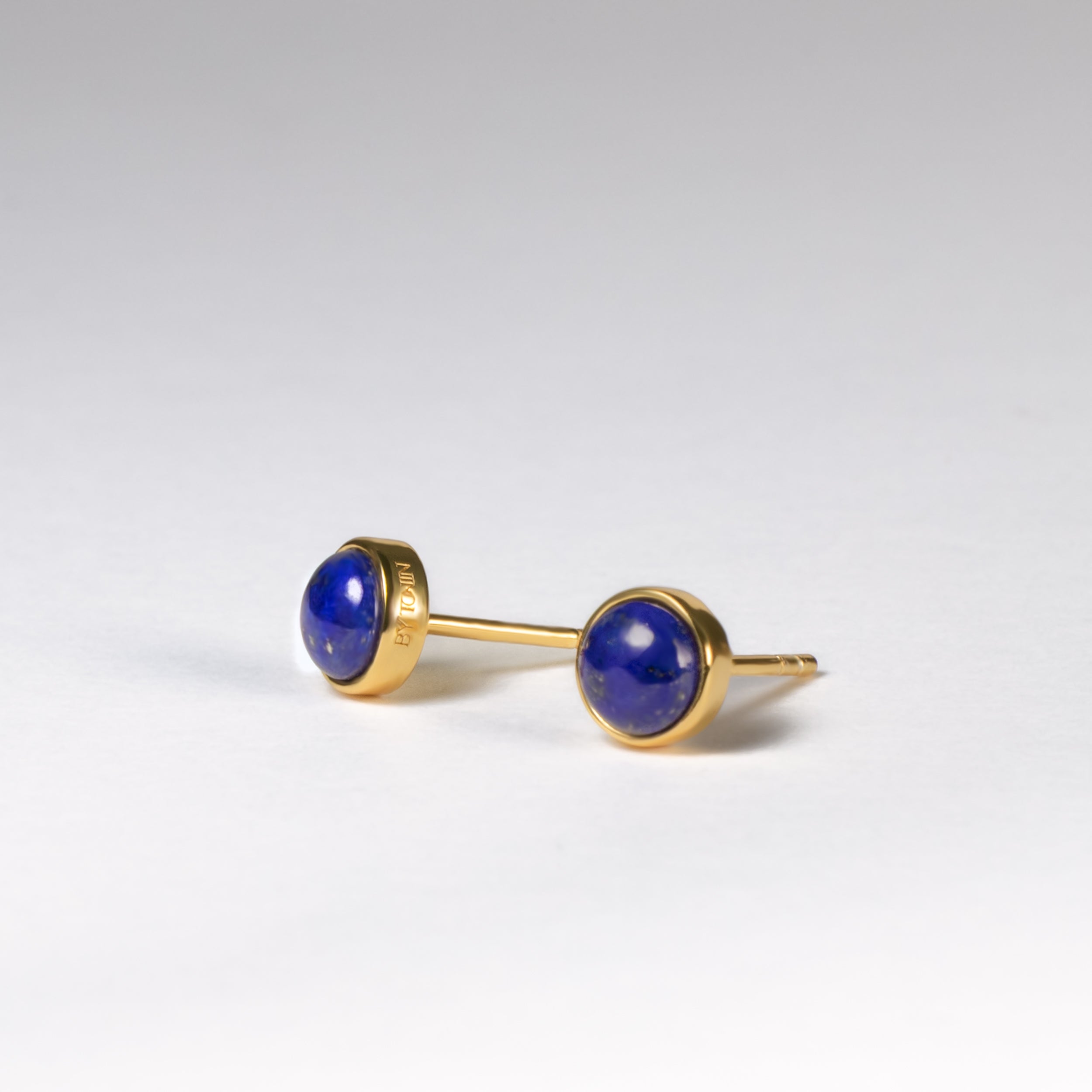 Embrace timeless charm with BY TONIN Belle Viv gold round stud earrings, showcasing captivating deep blue lapis lazuli for a touch of everyday luxury.