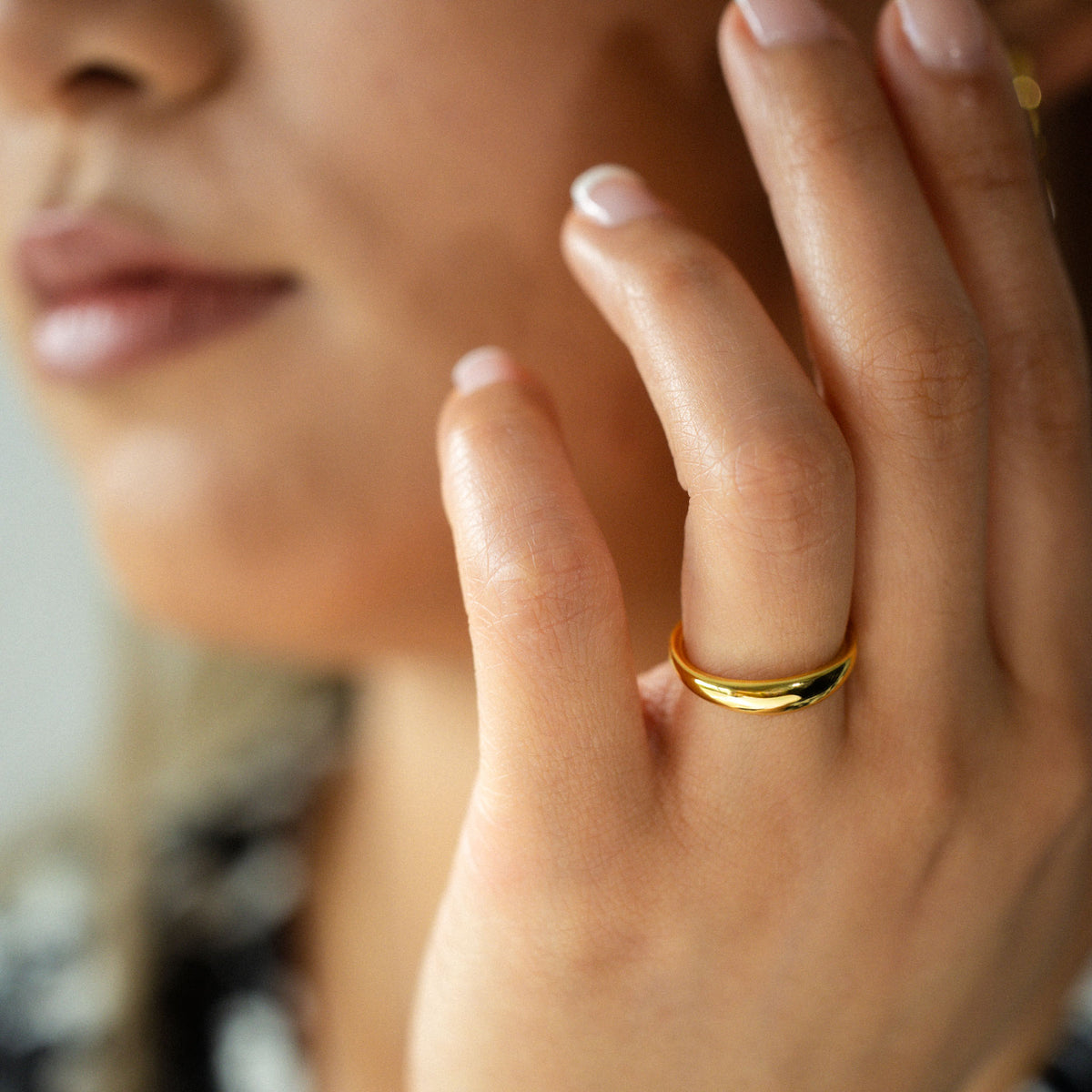Experience the refined comfort of BY TONIN's Heritage slim gold dome ring, showcased in a stunning close-up on a hand, highlighting its polished finish and versatile elegance.