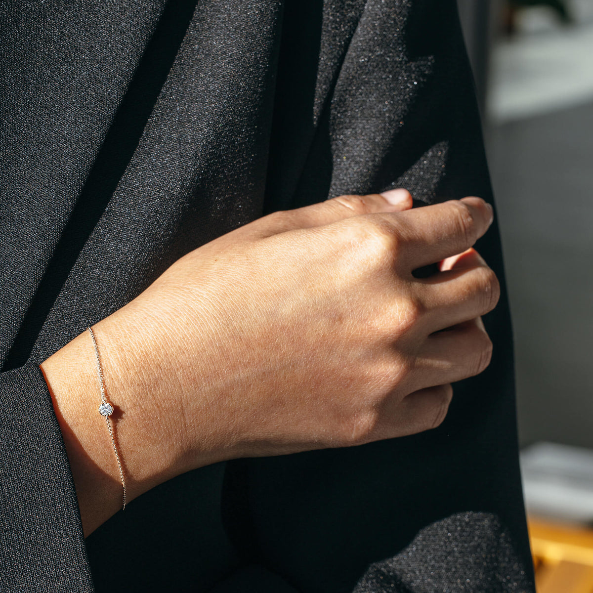 The 925 sterling silver diamond bracelet contrasted with a tailored black blazer, highlighting its versatility for modern workwear and transitioning from day to evening styling in New Zealand.