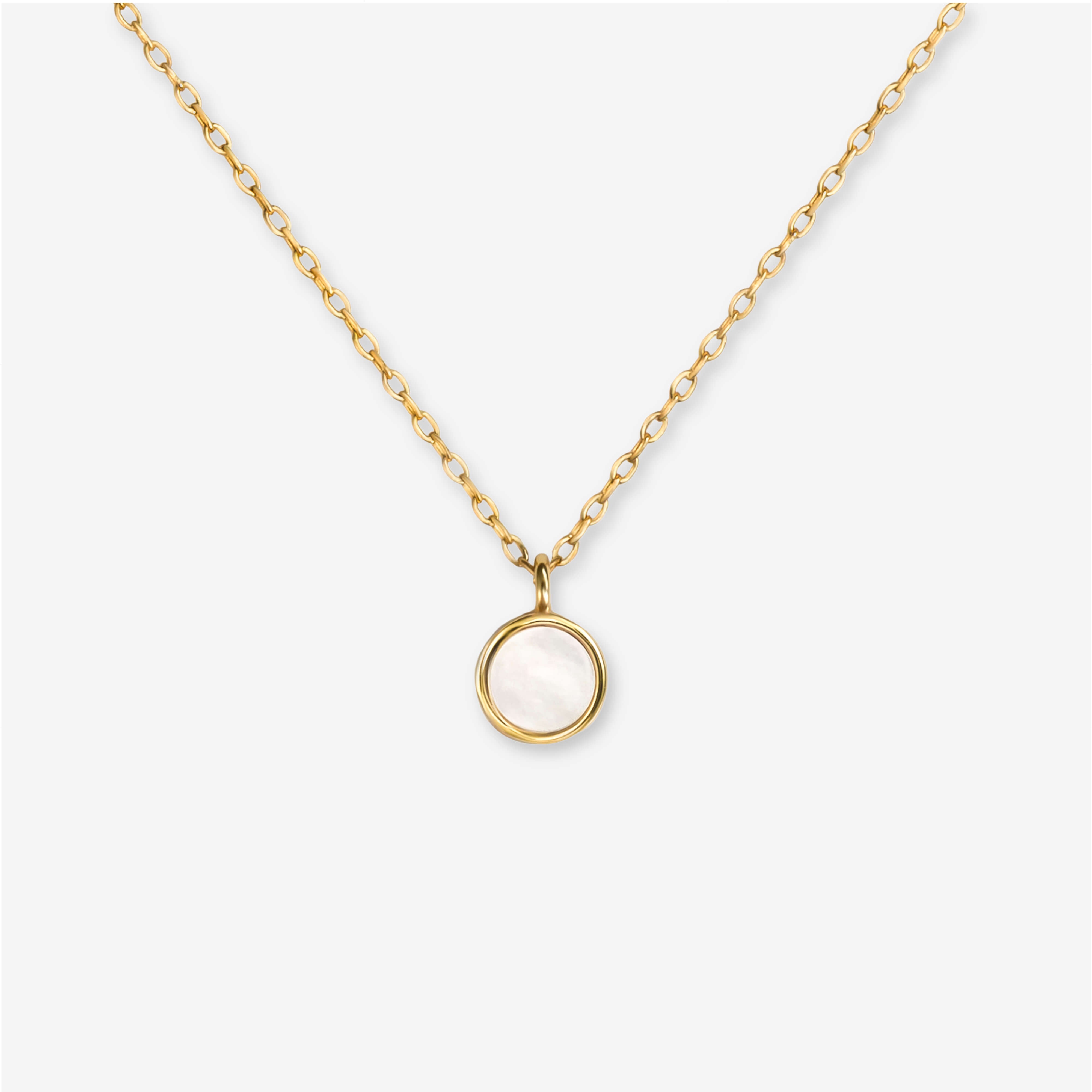 BY TONIN Heritage gold necklace with a luminous round mother of pearl pendant on white background.