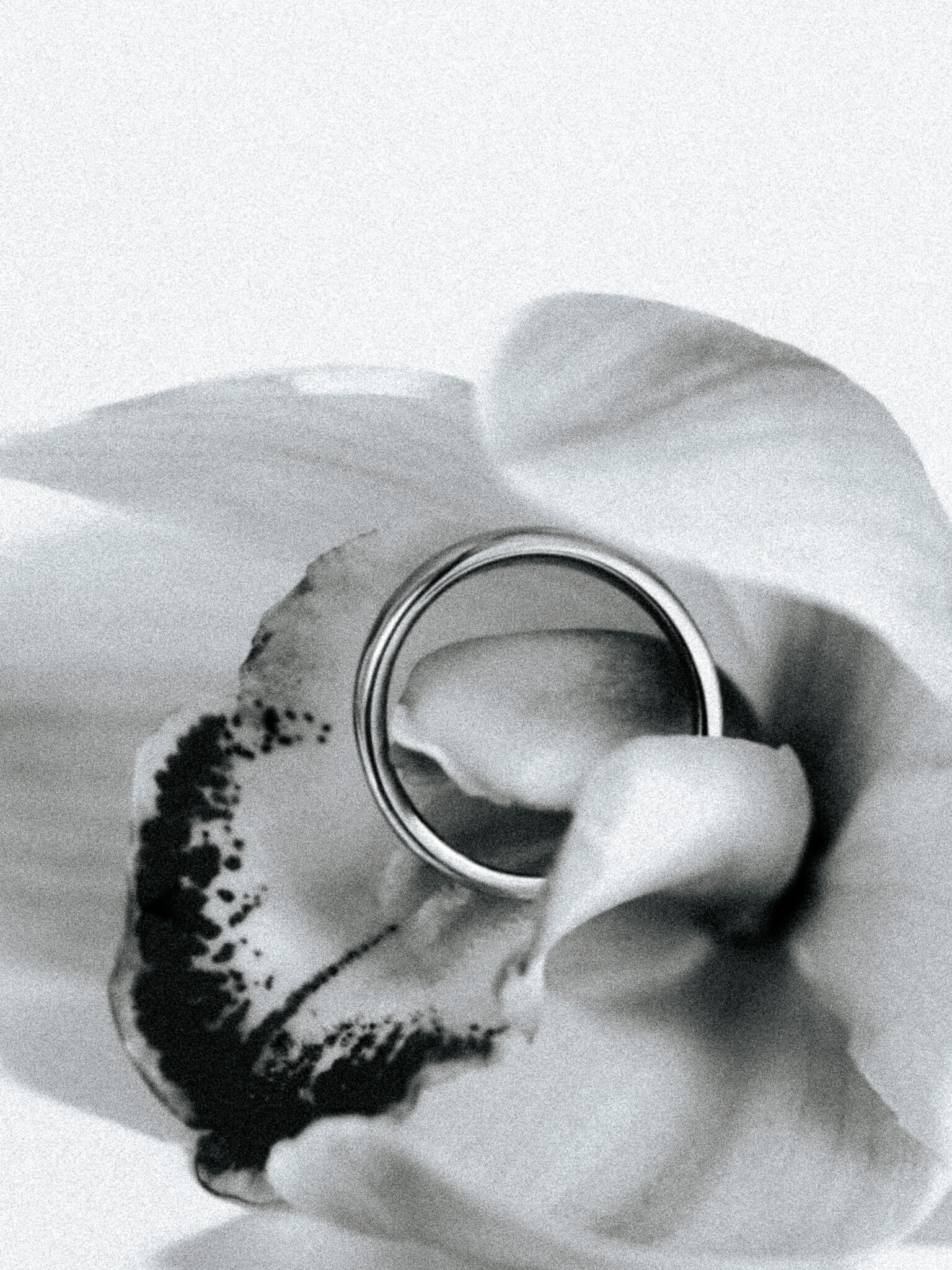 A slim dome ring nestled inside a flower 