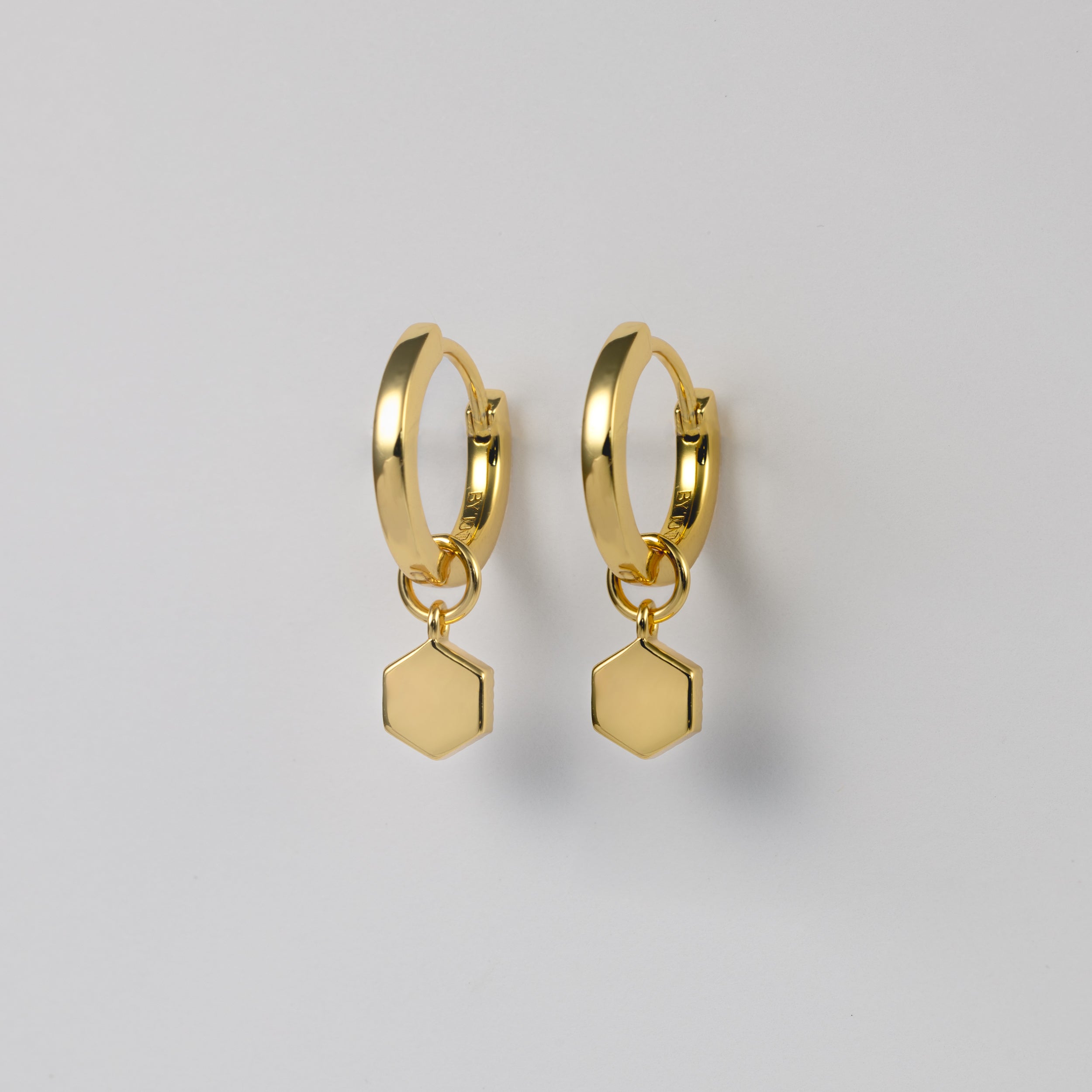 BY TONIN Belle Viv gold hoop earrings with plain hexagonal charms, showing the smooth back view.