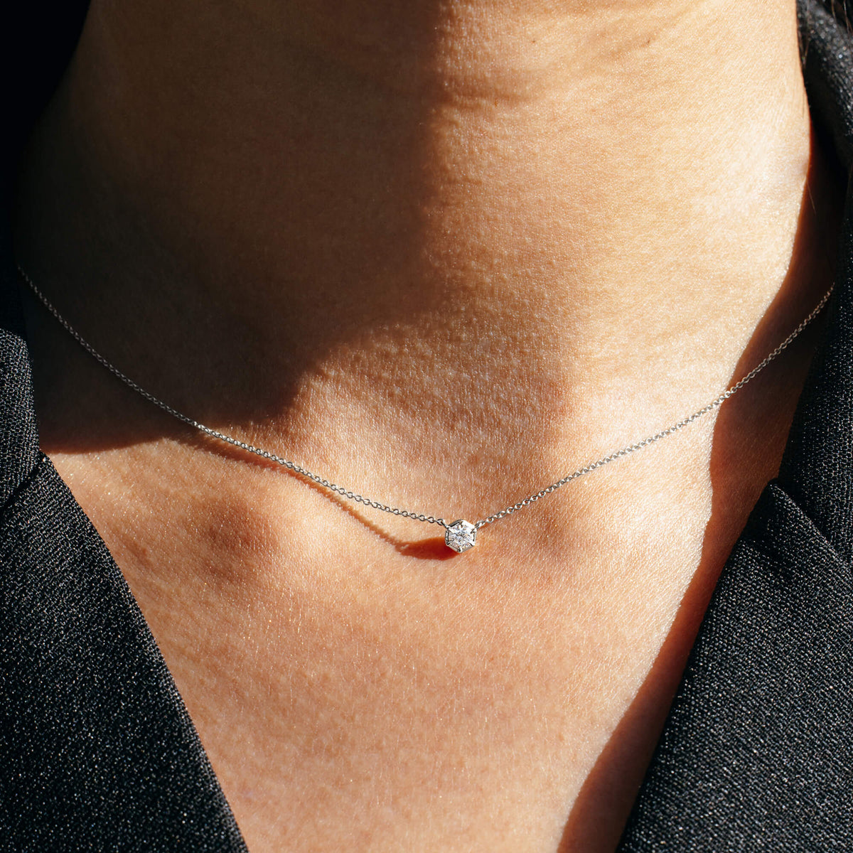 The Essential Diamonds Necklace in polished 925 sterling silver paired with a structured black blazer, illustrating contemporary styling transitions and the versatility of a 0.2 carat lab diamond piece within a modern professional wardrobe.