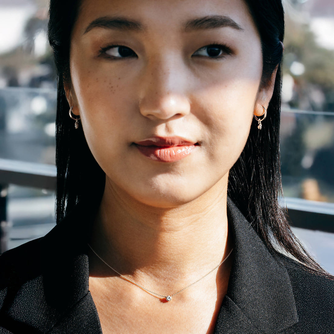 Studio view of a model styling the BY TONIN silver diamond drop earrings with a structured black blazer, illustrating contemporary wardrobe transitions and intentional modern jewellery for professional dressing.