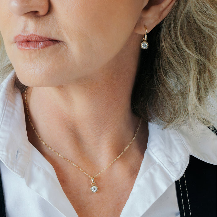 Lab grown diamond necklace NZ: BY TONIN 0.5ct solitaire gold pendant necklace worn with open collar shirt.