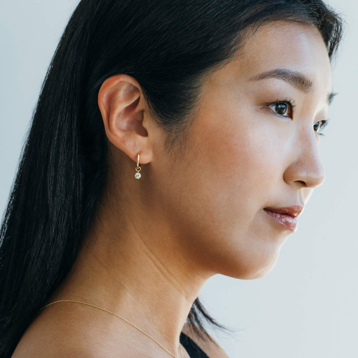 Profile perspective of model Hye Won Jang showcasing the delicate 9K gold lab diamond drop hoop earrings. A refined option within the BY TONIN bridal jewellery edit, designed for sensitive skin and lightweight daily wear